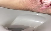 Shaved girl pooping a big one