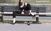 Busty brunette peeing on wooden bench