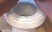 Tattooed babe shits over toilet