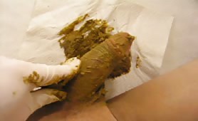 Rubbing green crap on his cock while jerking off