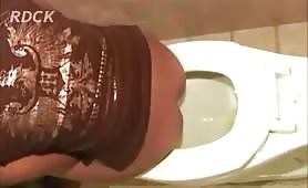 Two ebony girls pooping by turn in the toilet