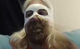 Blonde shemale smearing crap on her entire face