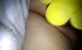 Sexy babe masturbating with a yellow flowerish dildo
