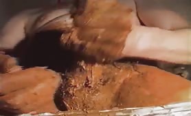 Smearing brown poop on his entire body