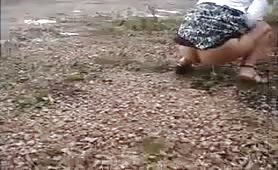 Girl Peeing on the side of the road