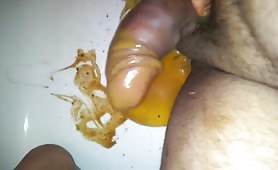 condom with poop and rubbing that shit over his cock