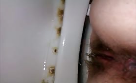 wife shitting on the toilet pooping close up