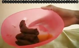 Ebony scat pooping in a bucket