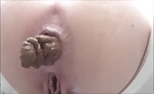 Slutty busty blonde babe pooping in closeup 