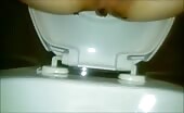 Sexy babe shitting a long turd in the toilet